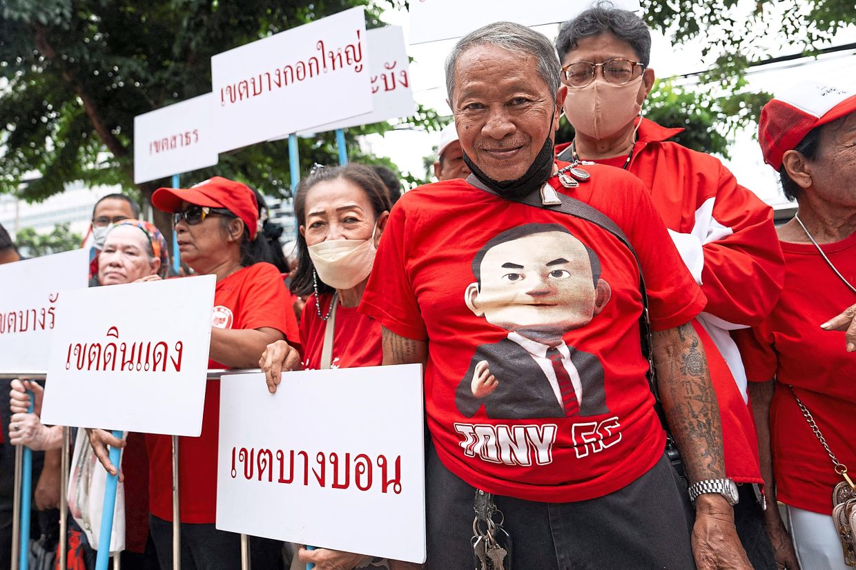 Staunch backing: Supporters of Thaksin gathering in front of the Criminal Court in Bangkok. — AFP