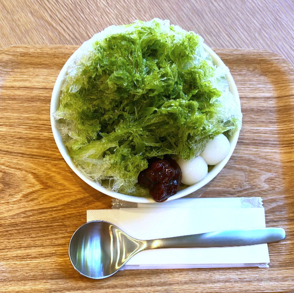This shows Matcha Kaki Gori, shaved ice desserts, served at Ogikubo Three Gardens in Tokyo, on July 20, 2025. (AP Photo/Yuri Kageyama)