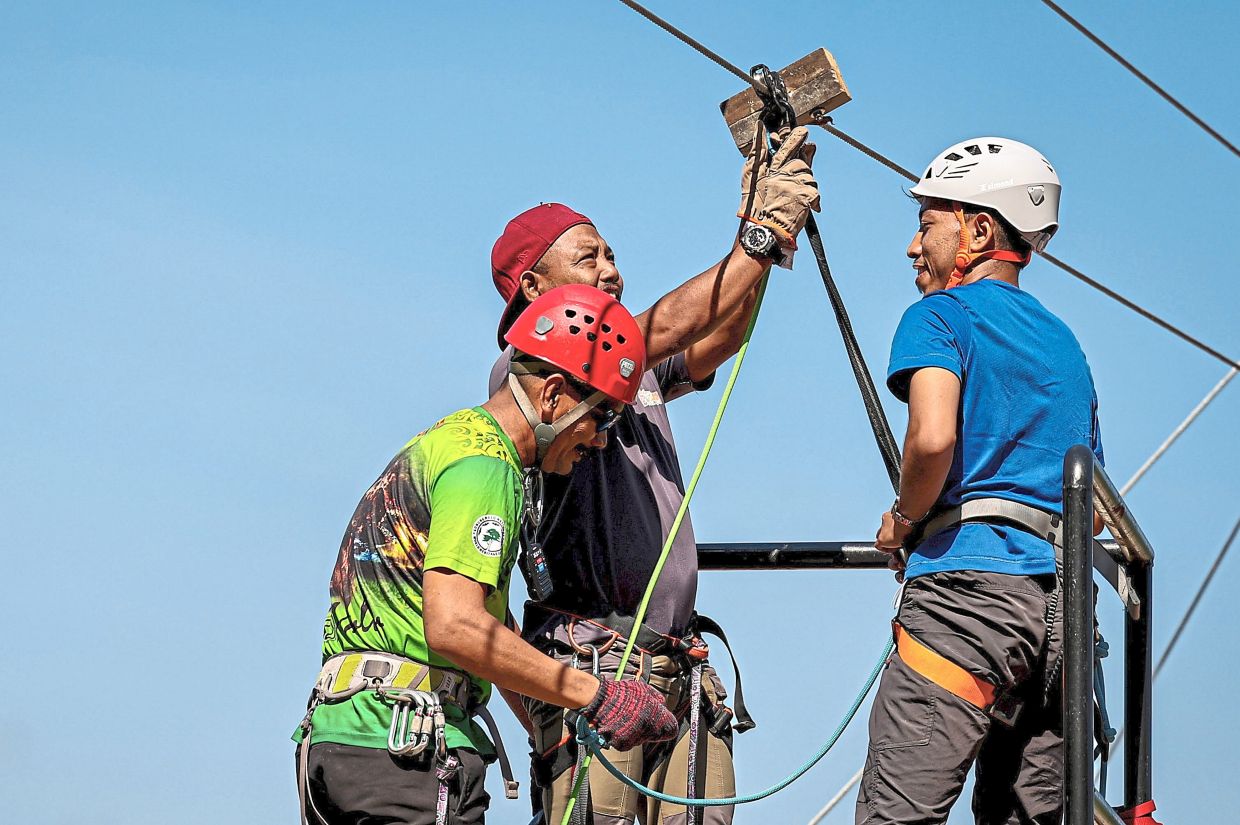 A participant being briefed on safety during the ‘Geopark Odyssey: Heritage & Archaeo Tourism’ programme exploring the ‘via ferrata’ and zipline at Gua Tagang. — Photos: Bernama