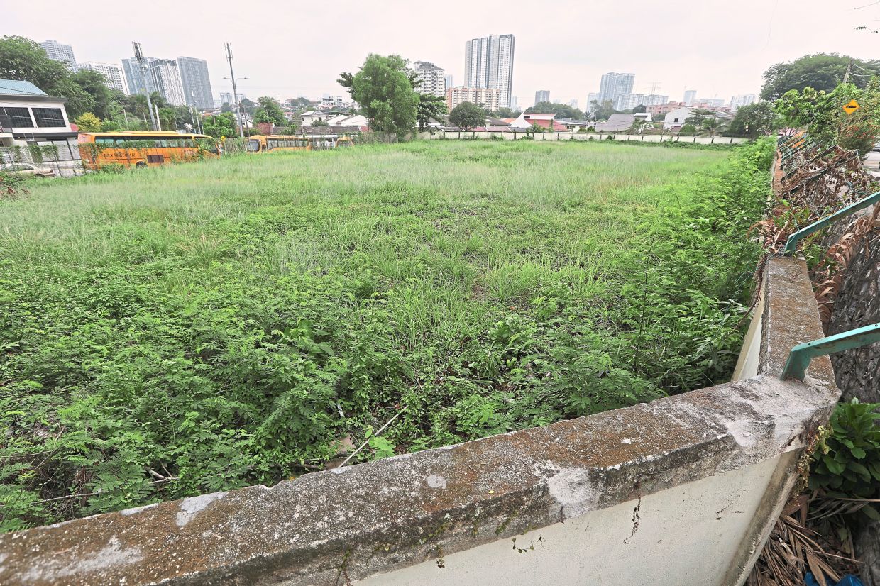 Lot 44432 in Happy Garden (above), a plot previously used for sewage treatment, is now being targeted by a developer seeking to build a sports complex. However, Chin (below) and other residents prefer to have a park for the benefit of residents and to avoid further congestion. — Photos: YAP CHEE HONG and FAIHAN GHANI/The Star