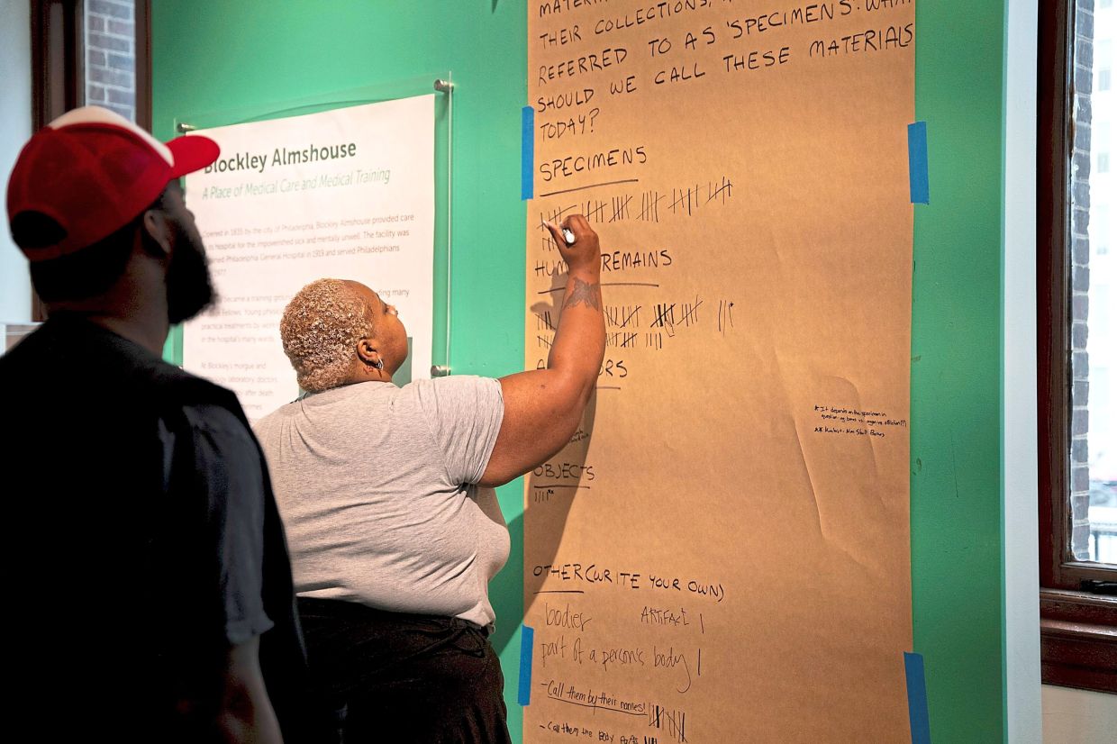 Visitors at a voting station, giving feedback on the language used for items of human origin in the museum. Photo: AP