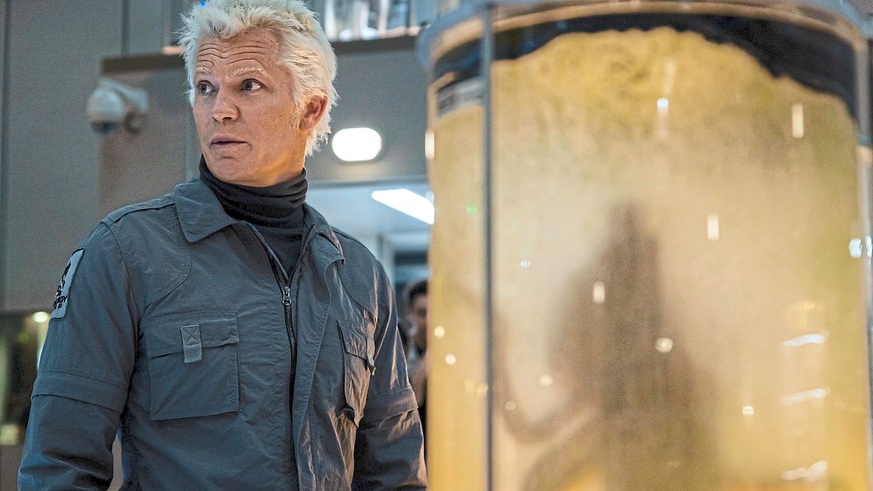 : 'A sinister silhouette behind a fragile-looking barrier? Just another day in corporate bioweapons research.'