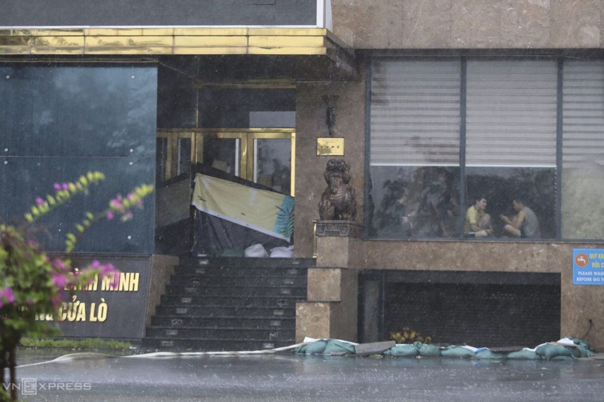 People sit inside a building in Nghe An province, Vietnam, Monday, Aug. 25, 2025, as Typhoon Kajiki was approaching. -- Photo: Duc Hung/VNExpress via AP