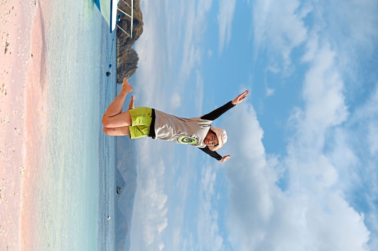 The writer jumping for joy at Labuan Bajo’s Pink Beach.