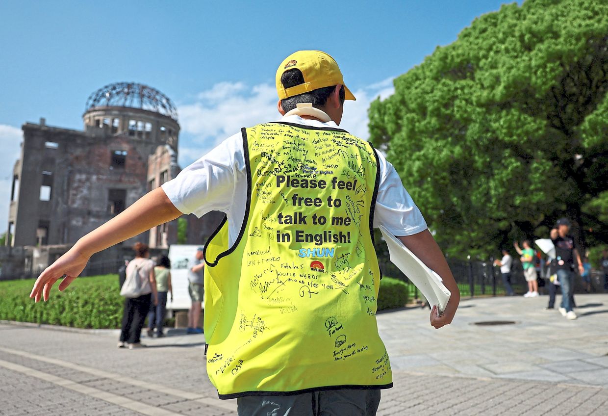 About twice a month, Shun makes his way to the peace park wearing a yellow bib. Photo: ISSEI KATO/Reuters