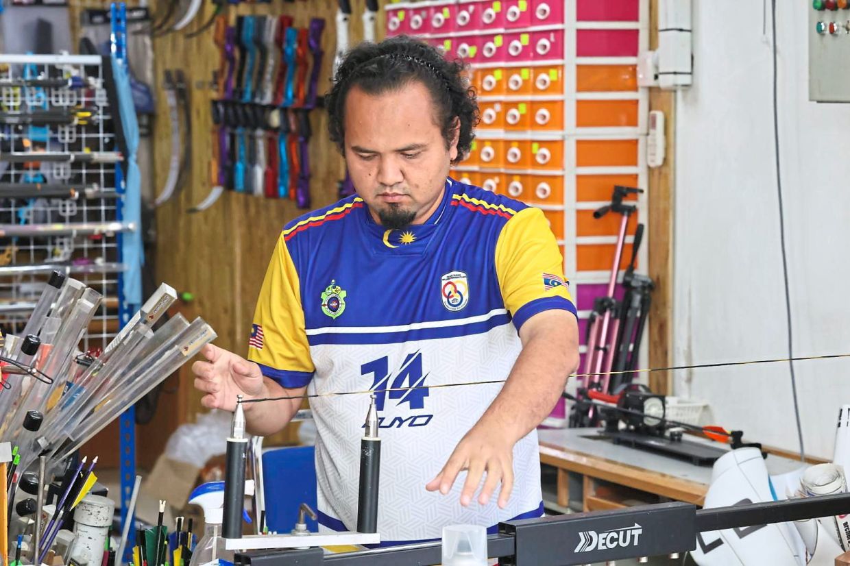 Adib working on a bow string serving jig.