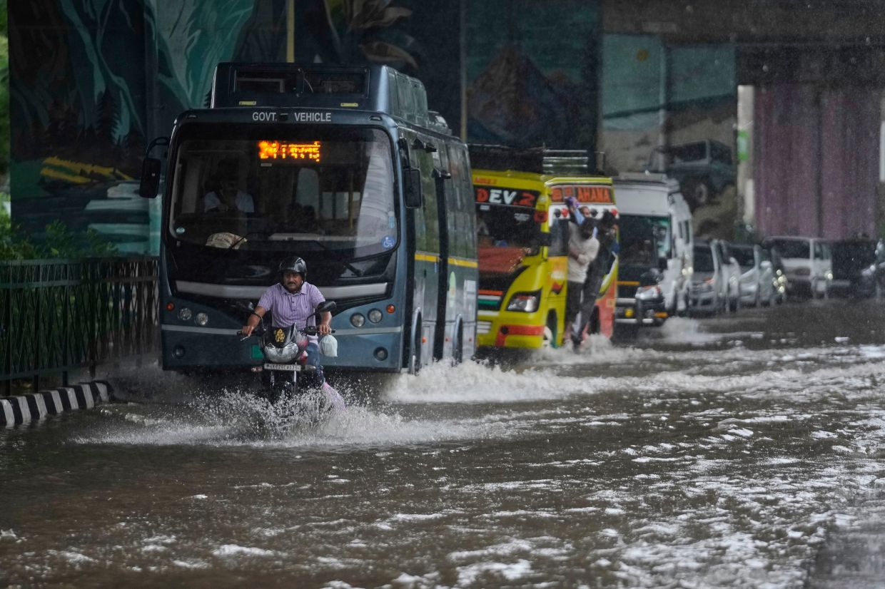 Commuters move through a flooded road after heavy rain in Jammu, India, Tuesday, Aug. 26, 2025. - Photo: AP 