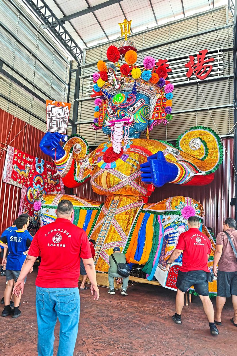 Volunteers assembling parts to make up the giant effigy of Tai Su Yeah at Pertubuhan Perayaan Yu Lan BM building in Jalan Pasar, Bukit Mertajam.