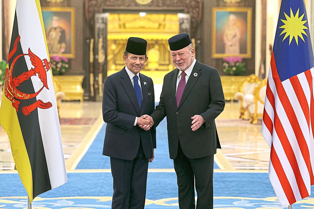 Royal visit: Sultan Ibrahim greeting Sultan Hassanal Bolkiah at Istana Negara. — Bernama