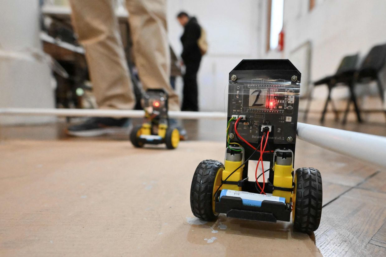 Robots built from recycled and disused electronic components are photographed during the 3rd Federal Cyberciruja Meeting in Buenos Aires. — AFP