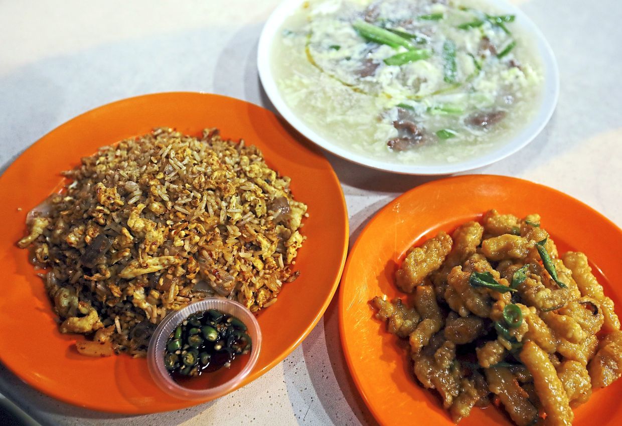 Clockwise, from left) Spicy egg fried rice, ‘kuey teow’ beef ginger and salted egg fried squid. — Photos: AZLINA ABDULLAH/The Star