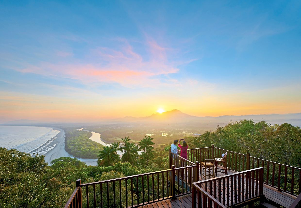 Sunrise hike offers picturesque landscapes, with majestic Mount Kinabalu in the distance.