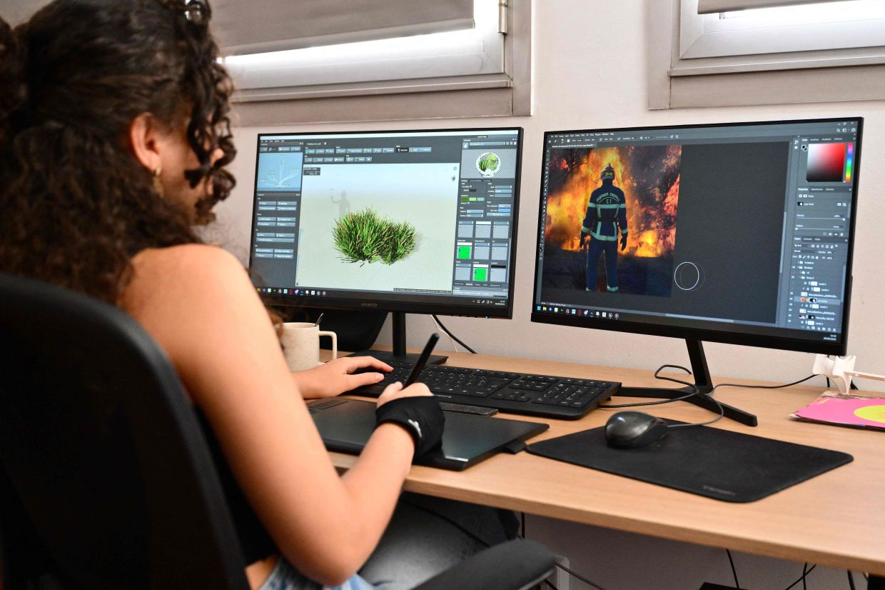 An employee of French video game studio Exkee works on the development of the studio's upcoming video game 'Rescue Ops: Wildfire', in Marseille. — AFP