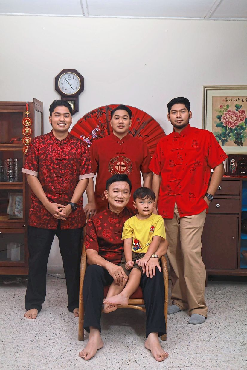 The family celebrates both Chinese New Year and Hari Raya. Here Uncle Mike poses with his three sons and grandson. Photos: — Handout