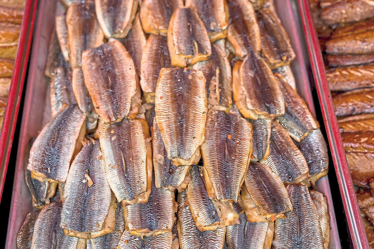 Smoked fish is displayed for sale at a market in the town of Roja. — AFP Megnis says all the fish canning companies have either gone out of business or turned their production lines into making more valuable export-grade products. — AFP