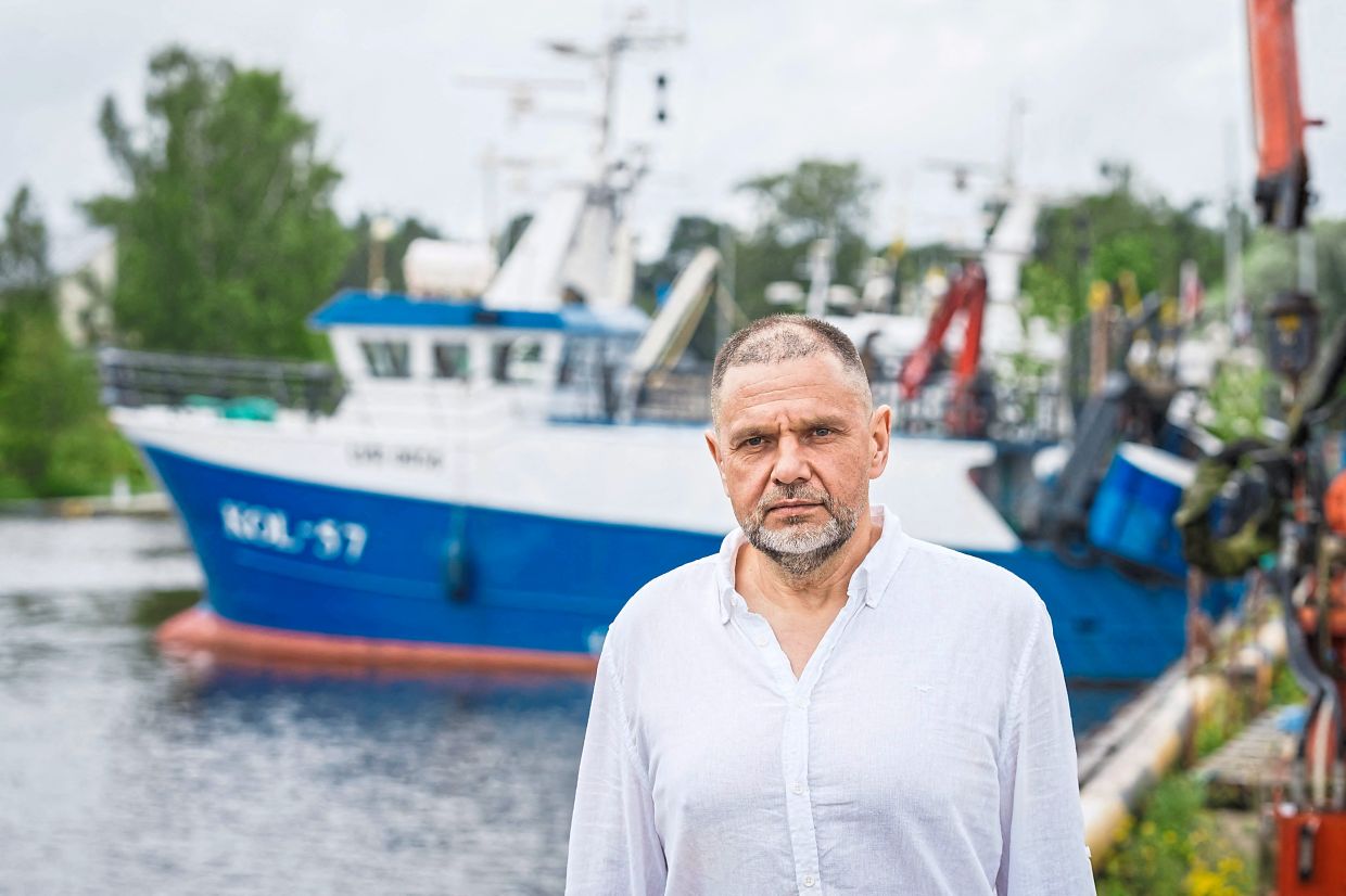 Janis Megnis, chief of the Roja port administration, poses for a photo at the port of Roja, Latvia on July 12, 2025. With fewer cod in the Baltic sea, communities all along the Latvian coast that were once heavily reliant on fishing have been diversifying into tourism and seafood processing. (Photo by Gints Ivuskans / AFP)