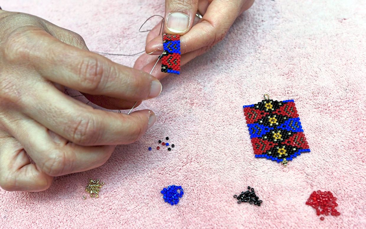Crafting with beads requires careful focus and steady hands.