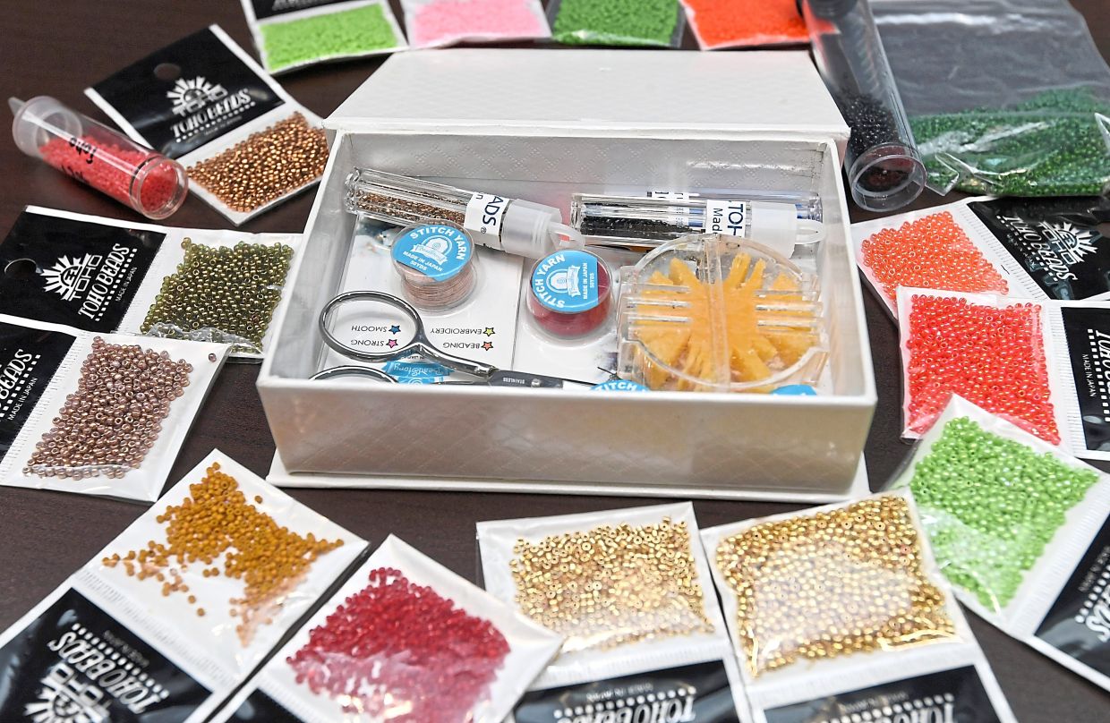 Sharmila uses a variety of beads and tools to craft her intricate earring and pendant designs.