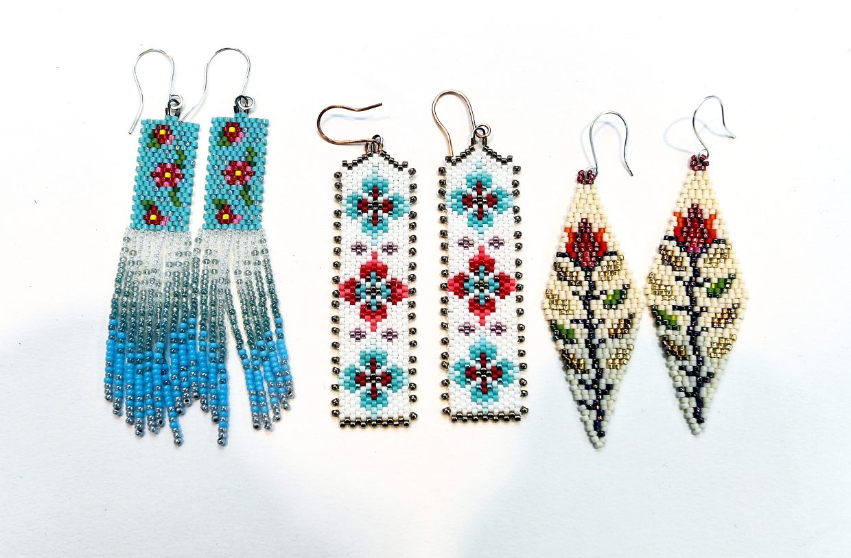 Peranakan-themed earrings (left and centre) alongside a floral-inspired beaded design.