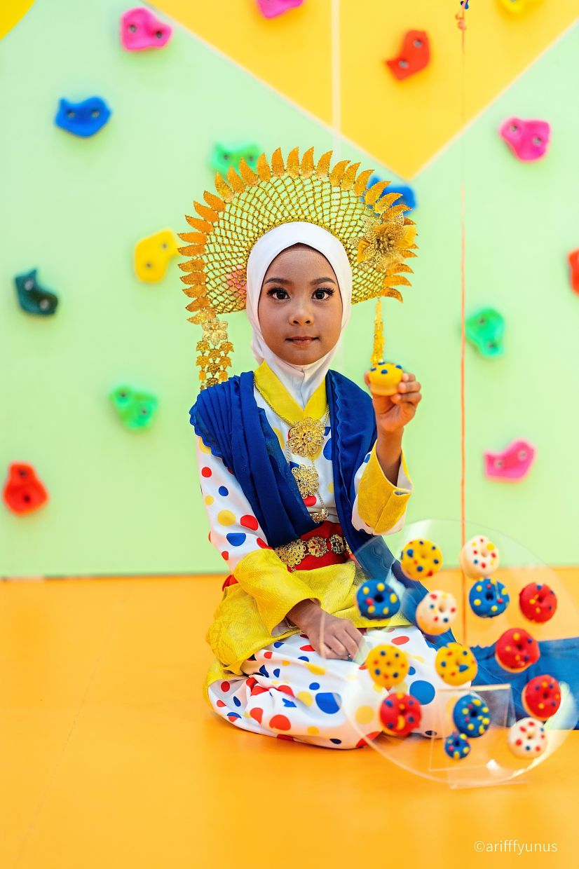 Ilyaana Muhamad Saifuddin models in a Puteri Perak costume.