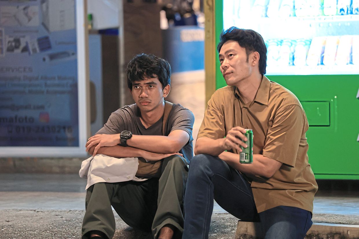 A touching scene in the movie where Uncle Mike (Andy Teh) connects with young Rafie. Photo: Handout