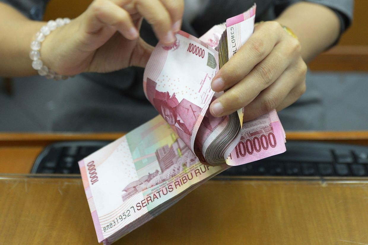 Indonesian rupiah, shares fall as political protests rock Jakarta