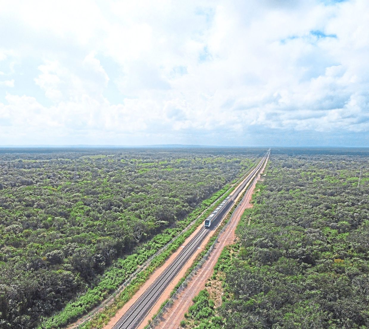 The inaugural Mayan Train with President Andrés Manuel López Obrador on board passes near Chochola, Quintana Roo State, Mexico, Dec. 15, 2023. (AP Photo/Martin Zetina, File)