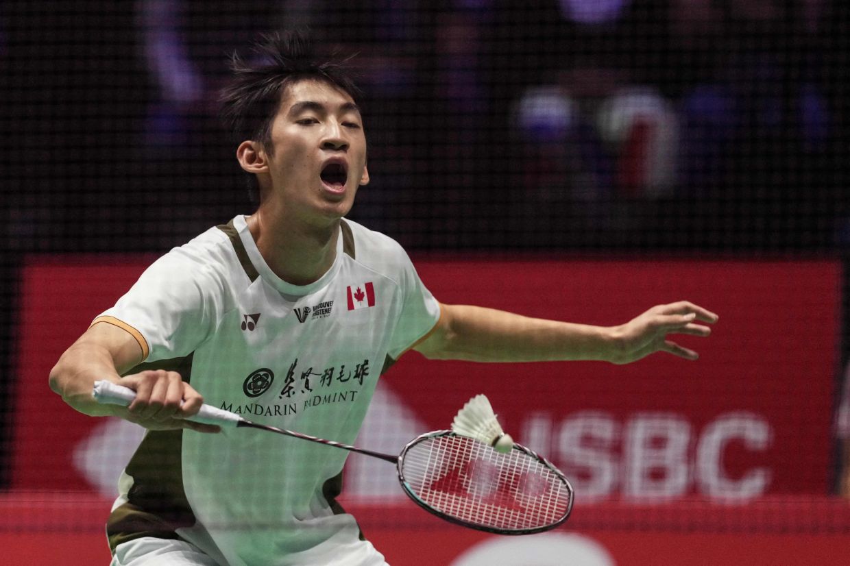 Canada's Victor Lai returns the shuttlecock to Singapore's Loh Kean Yew during their men's single match at the Badminton BWF World Championships at the Adidas Arena in Paris, on Friday, August 29, 2025. -- Photo by Dimitar DILKOFF / AFP