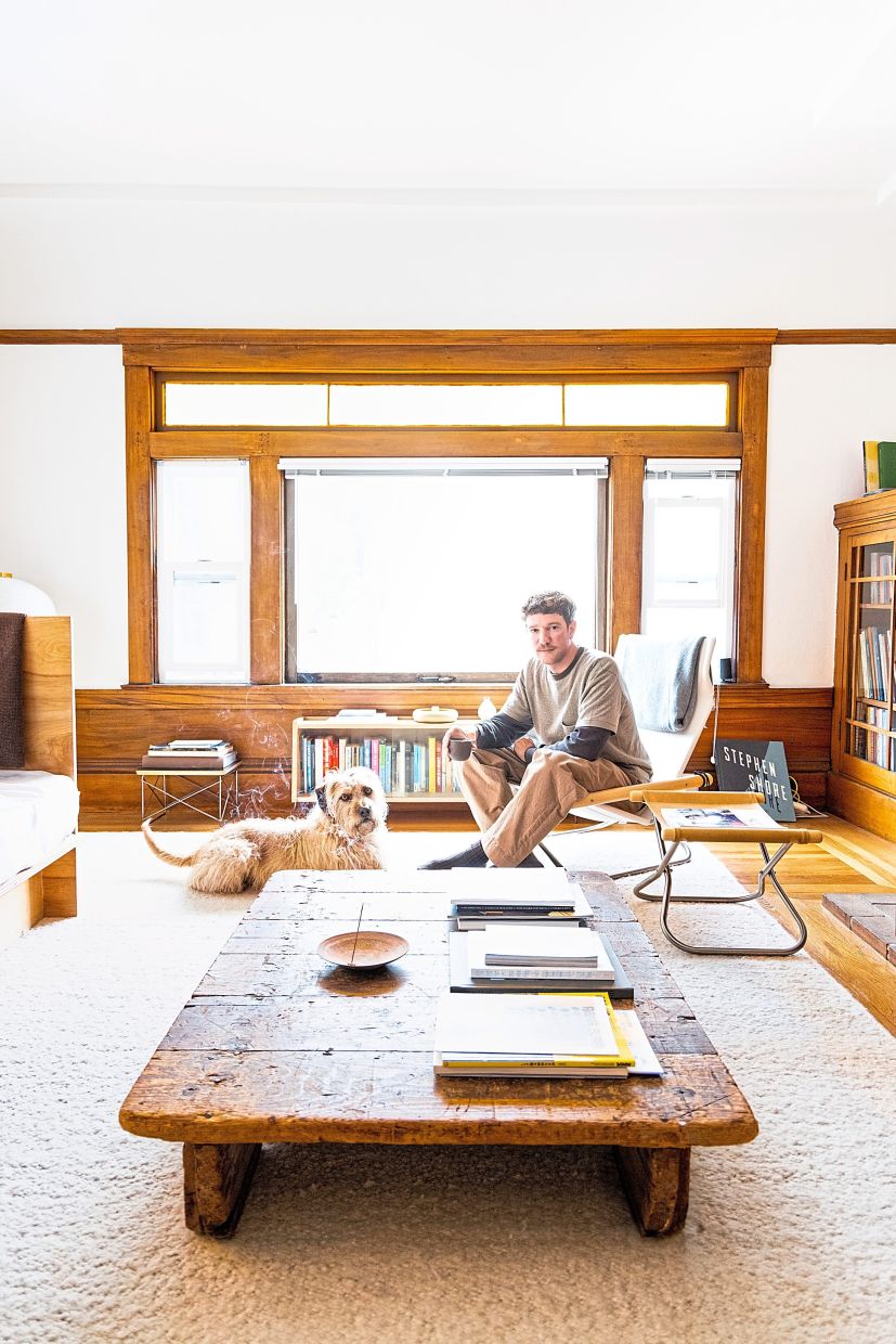 Gerrits, at his home in San Francisco, drinks coffee from a cup that is part of a broader collection of pottery and ceramics.