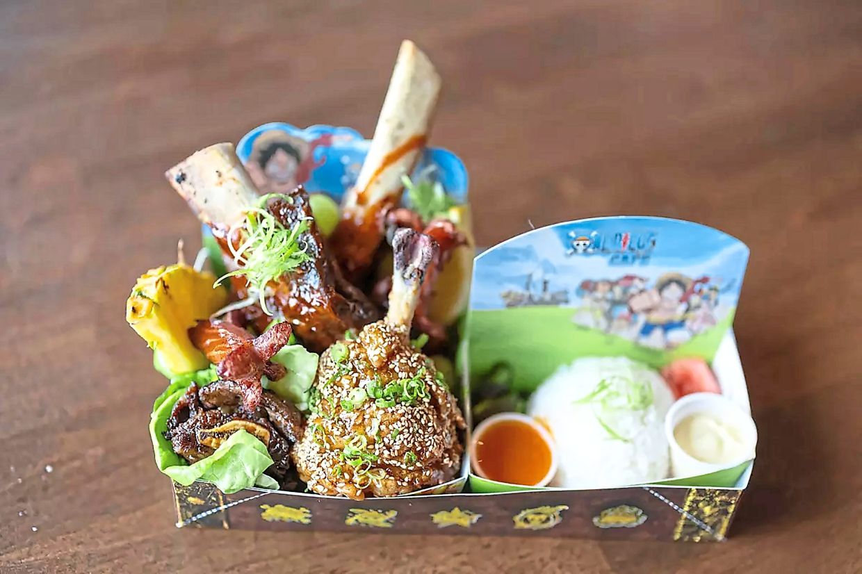 The cafe serves food inspired by the anime series such as this Mighty Meats Pirate Platter of orange sauce chicken pops, Korean BBQ-style ribs, Kurobuta sausage and L.A.-style galbi with a side of rice.