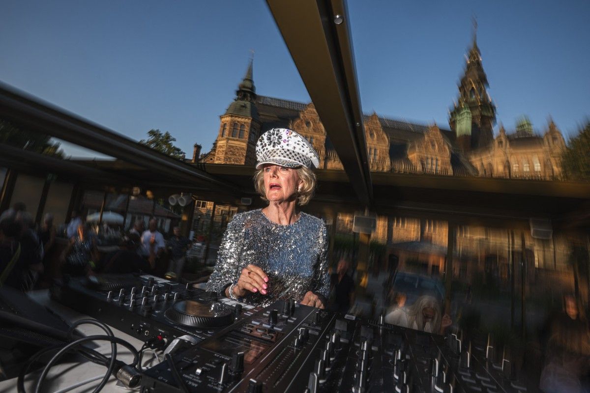 81-year-old Madelein Mansson, aka 'DJ Gloria', performs at Josefina, an outdoor summer bar and club in Stockholm, Sweden, on July 18, 2025.