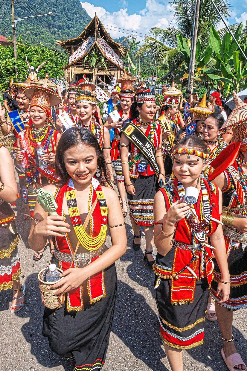 The Bidayuh community of Kampung Taee parading through the village.