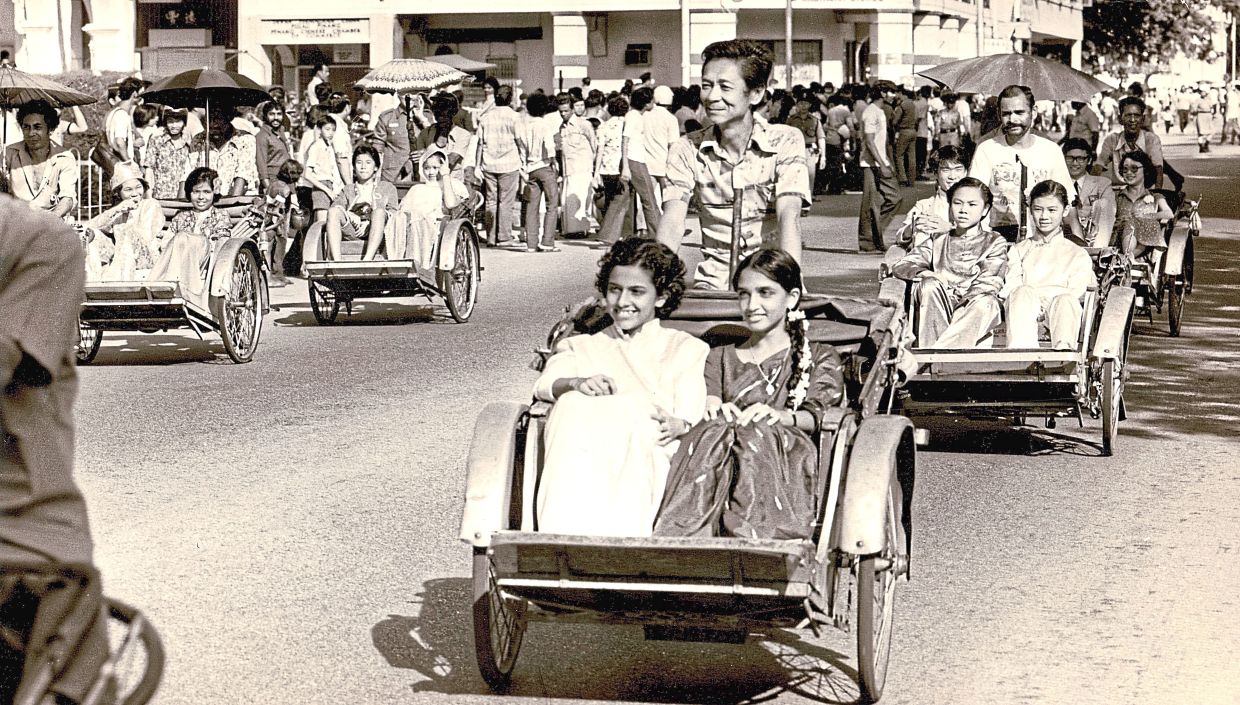 1979: A lively display of unity in diversity as colourfully dressed “couples” representing Malaysia’s many races rode by in trishaws. — CHAN LOOI TAT/The Star