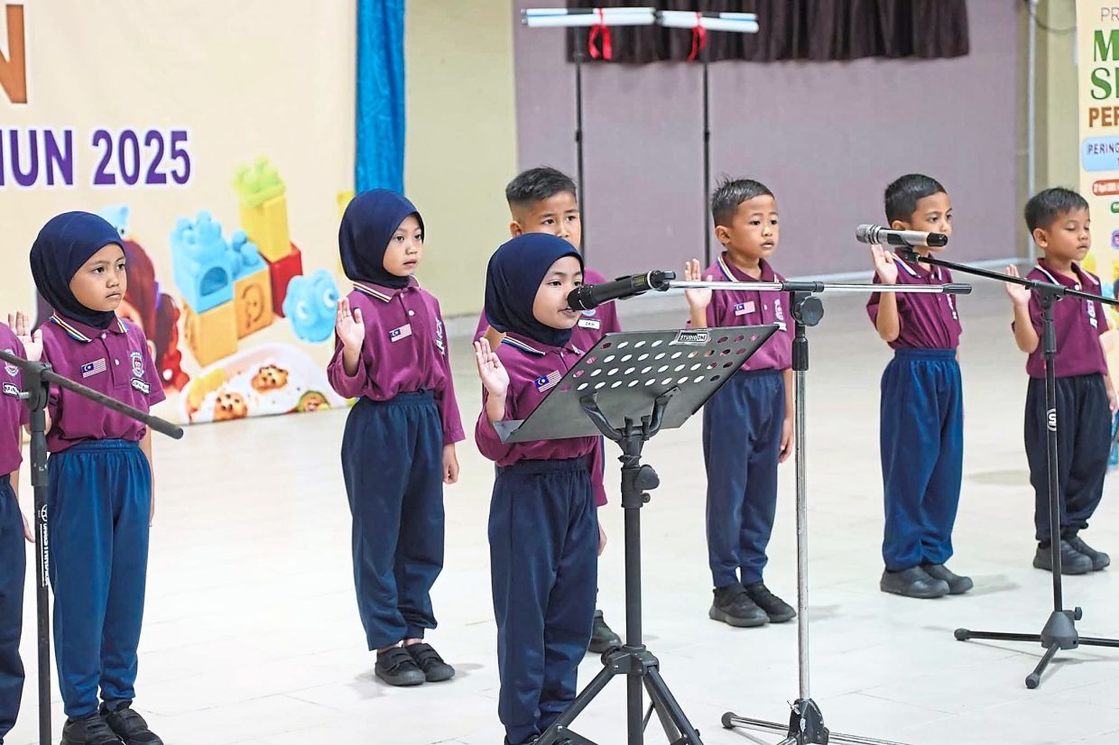Pupils from a Unity Kindergarten reciting a pledge during a school event. With 1,741 centres nationwide, these multiethnic preschools under the National Unity Ministry aim to instil values of respect, empathy and national identity from an early age.