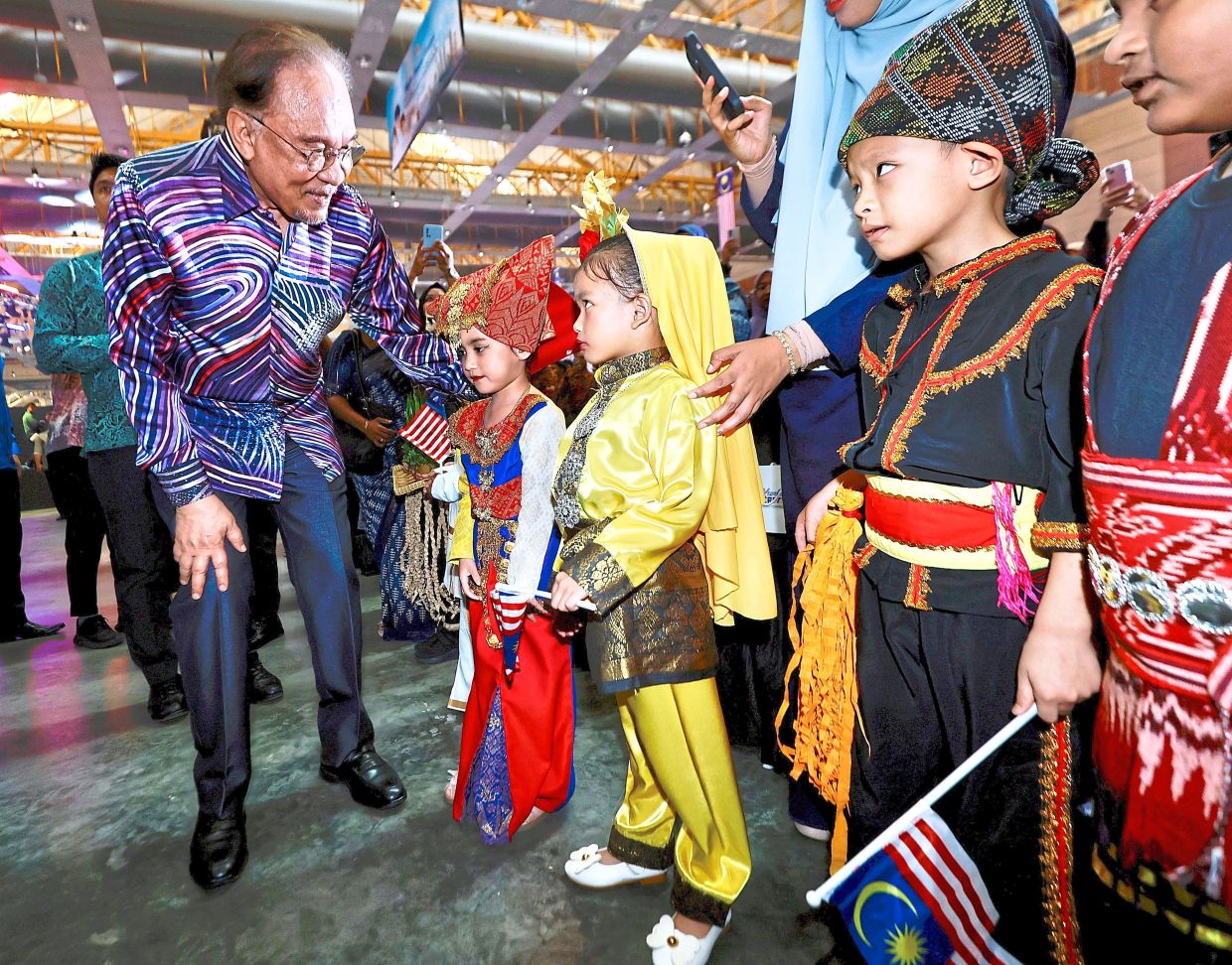 Colours of Malaysia: Anwar greeting children dressed in traditional attire during a National Day celebration at Malaysia Agro Exposition Park, Serdang. — FAIHAN GHANI/The Star