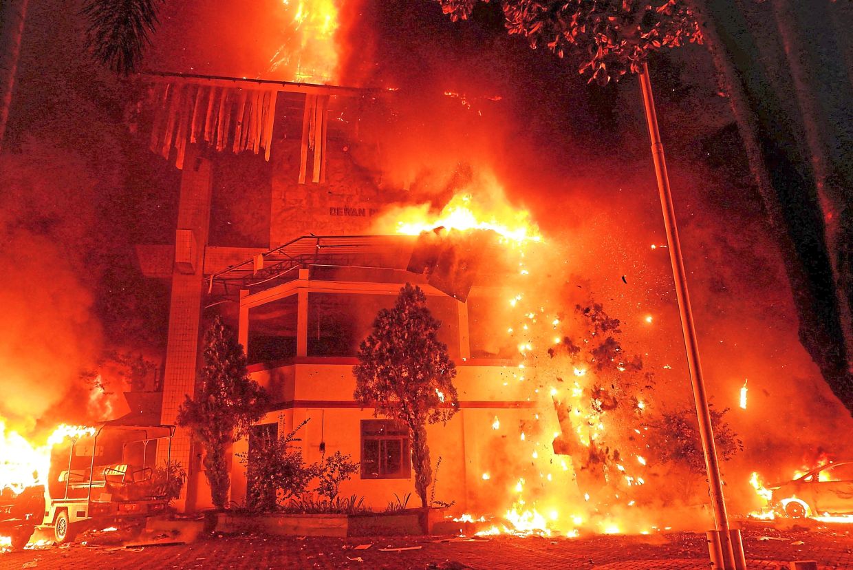 The building of Makassar city council being set on fire during a protest in Makassar.