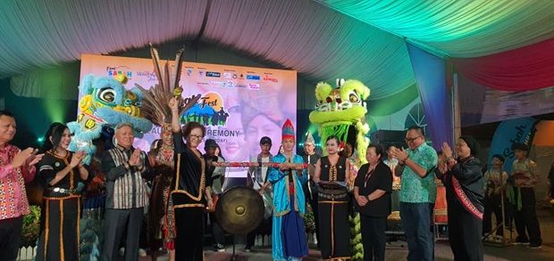 Liew preparing to beat the gong to symbolise the start of Sabah Fest.