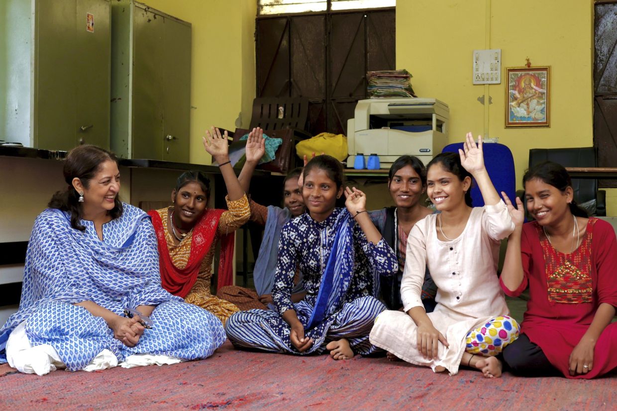 In this undated photo provided by the Ramon Magsaysay Award Foundation, winner Safeena Husain (left), founder and board member of the Foundation to Educate Girls, talks to a group in Rajasthan, India. -- Ramon Magsaysay Award Foundation via AP