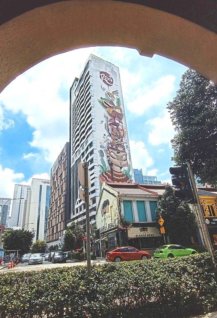 ‘Courage to Dream’ mural on a hotel features the image of a Dayak woman.
