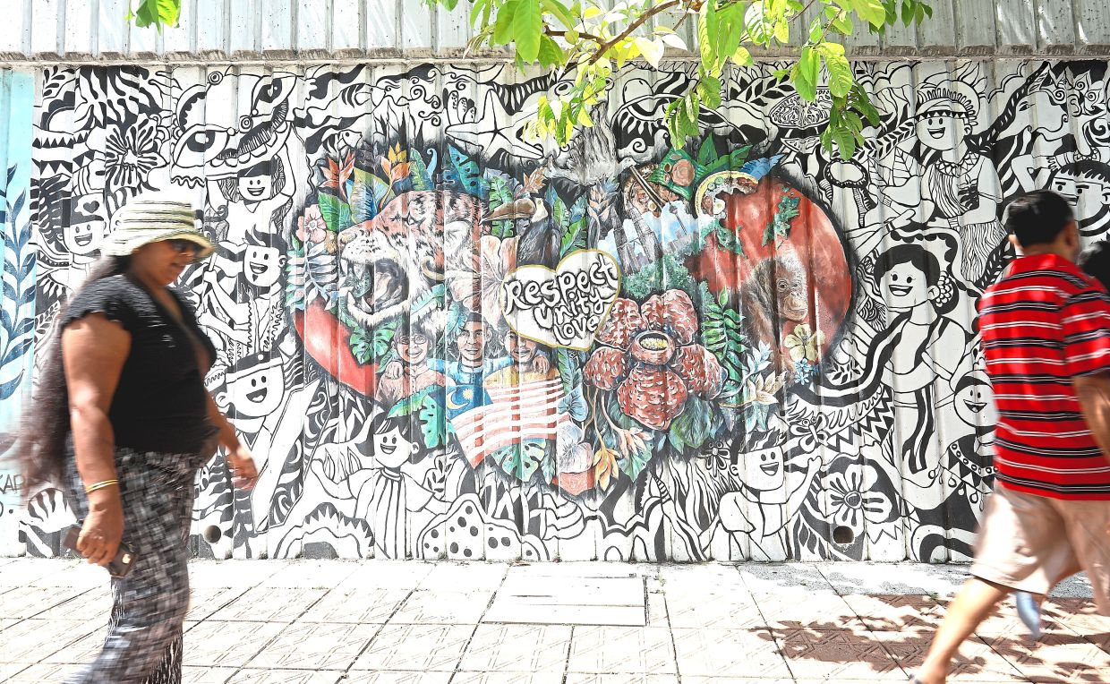 Street art along Jalan Raja Chulan promoting respect, unity and love.