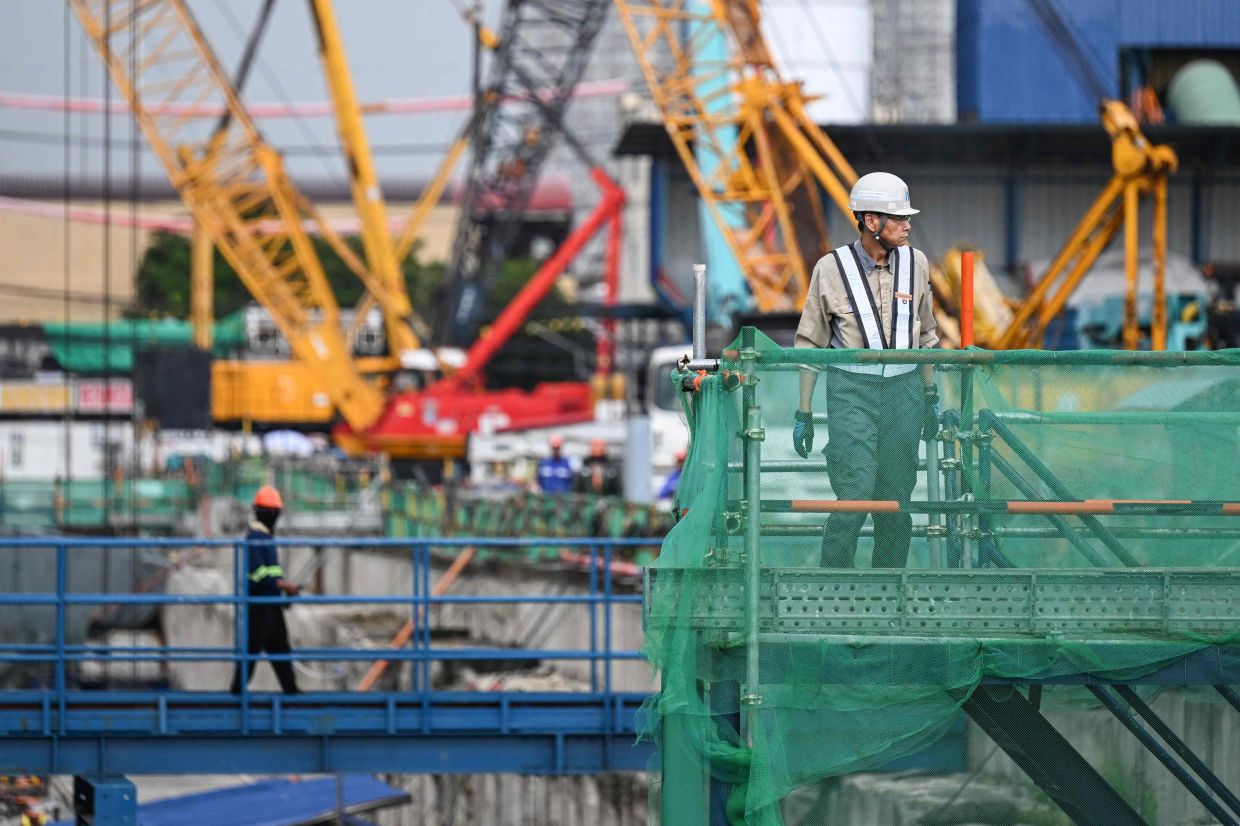 Workers walk around the construction site of the Metro Manila Subway Project (MMSP) during an inspection in Quezon City, Metro Manila. -- Photo by Jam STA ROSA / AFP