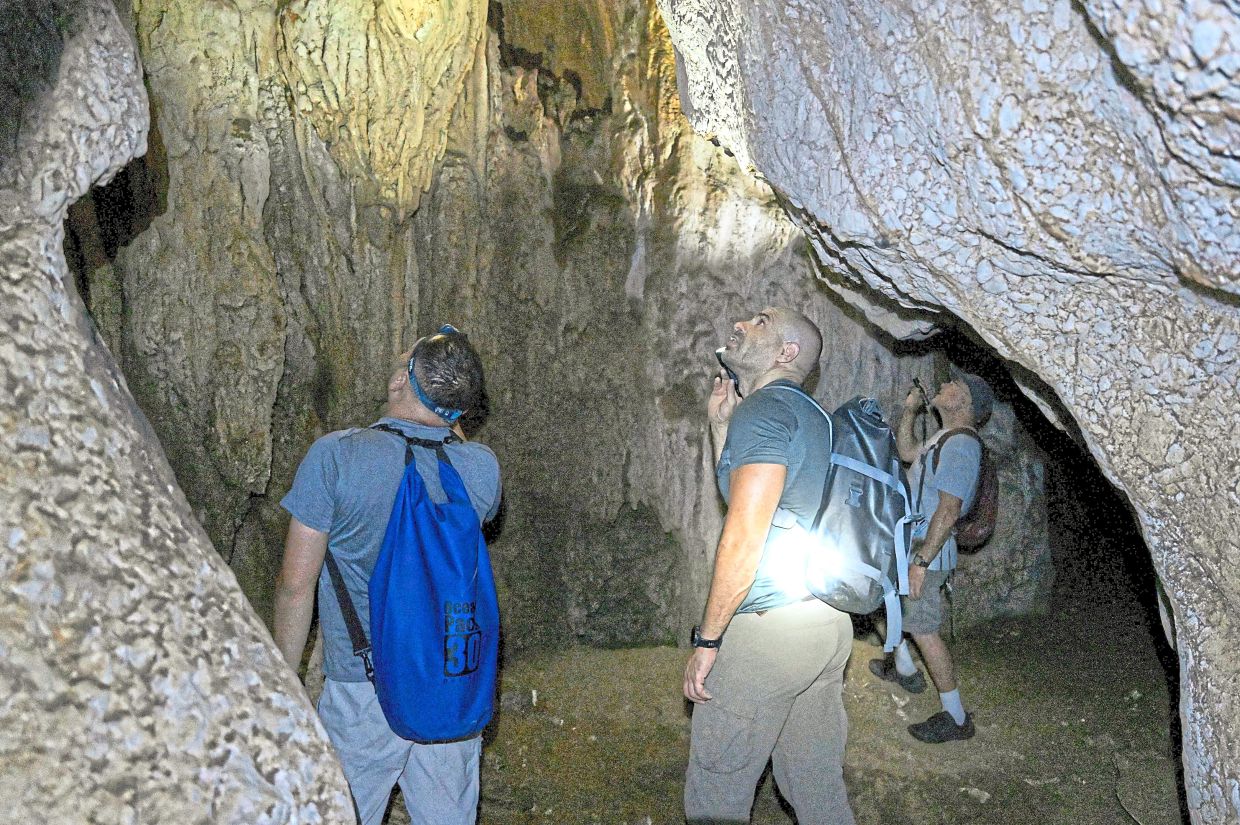 Expert consultants and conservationists searching for new species in a cave in Phnom Proek district in Battambang province.