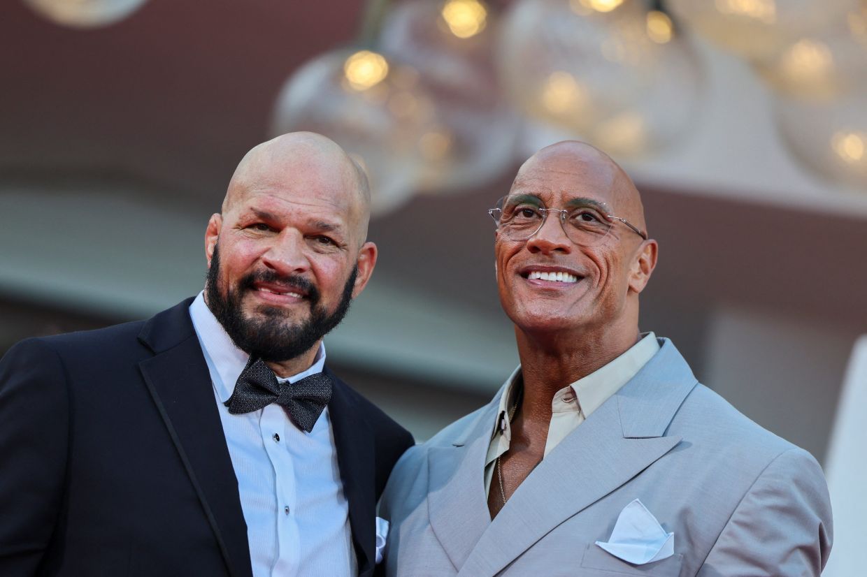 Cast member Dwayne Johnson poses with Mark Kerr on the red carpet during arrivals for the screening 'The Smashing Machine' at the 82nd Venice Film Festival, Venice, Italy, Sept 1, 2025. Photo: Reuters
