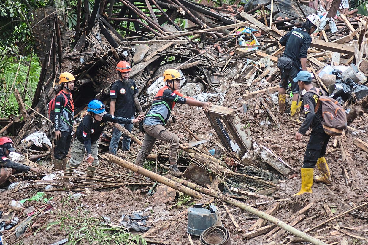 As climate change brings heavier rains, more landslides are occurring. Here, members of Indonesia’s National Search and Rescue Agency search for survivors of a landslide in Cipongkor, West Java province, earlier this year. — AFP