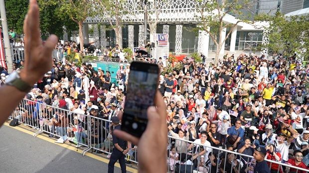 A 'Legasi: Bomba The Movie' actor taking photos of the crowd from a firetruck with the unreleased HONOR smartphone.