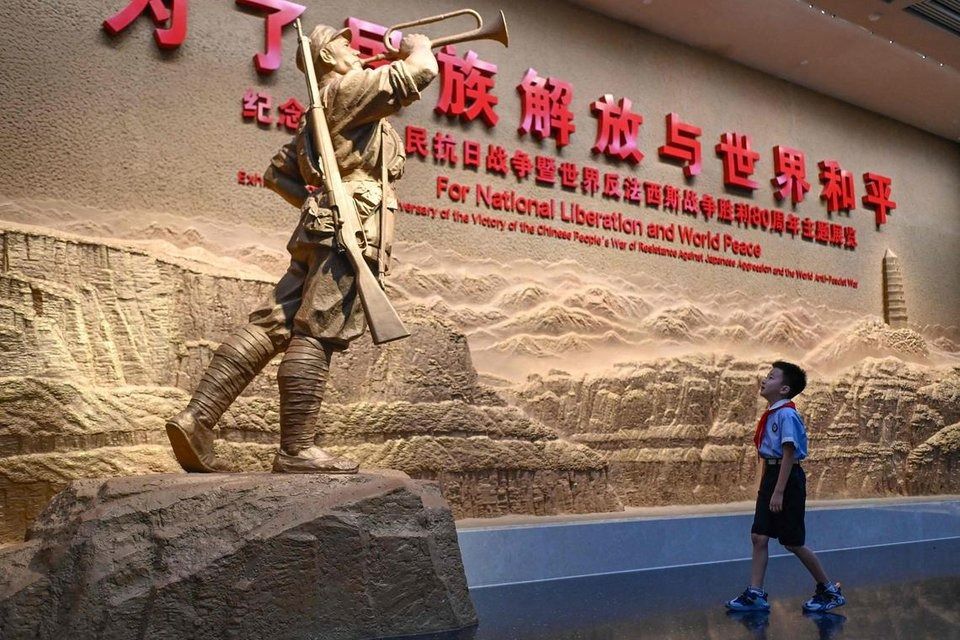 A child looks at a sculpture at the Museum of the War of Chinese People’s Resistance Against Japanese Aggression in Beijing on Aug 27. - Photo: AFP