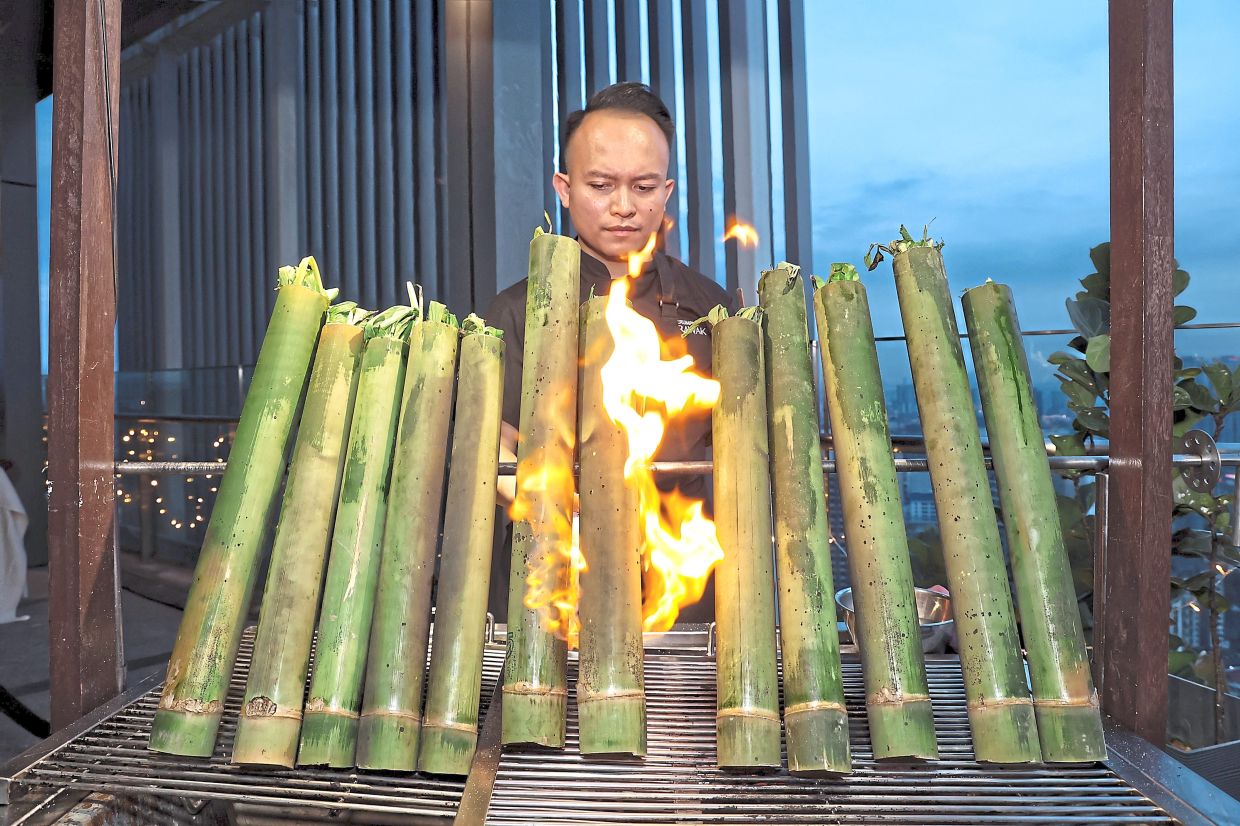 Chicken Pansuh being cooked in bamboo over a fire.