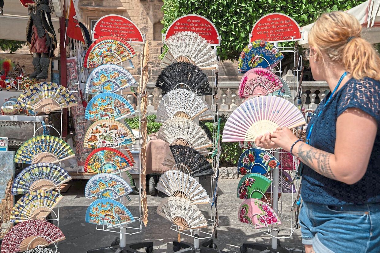 Hand fans for sale during a heatwave in Palermo, Italy. Blistering heat is sweeping across south-east Europe. — Francesca Volpi/Bloomberg