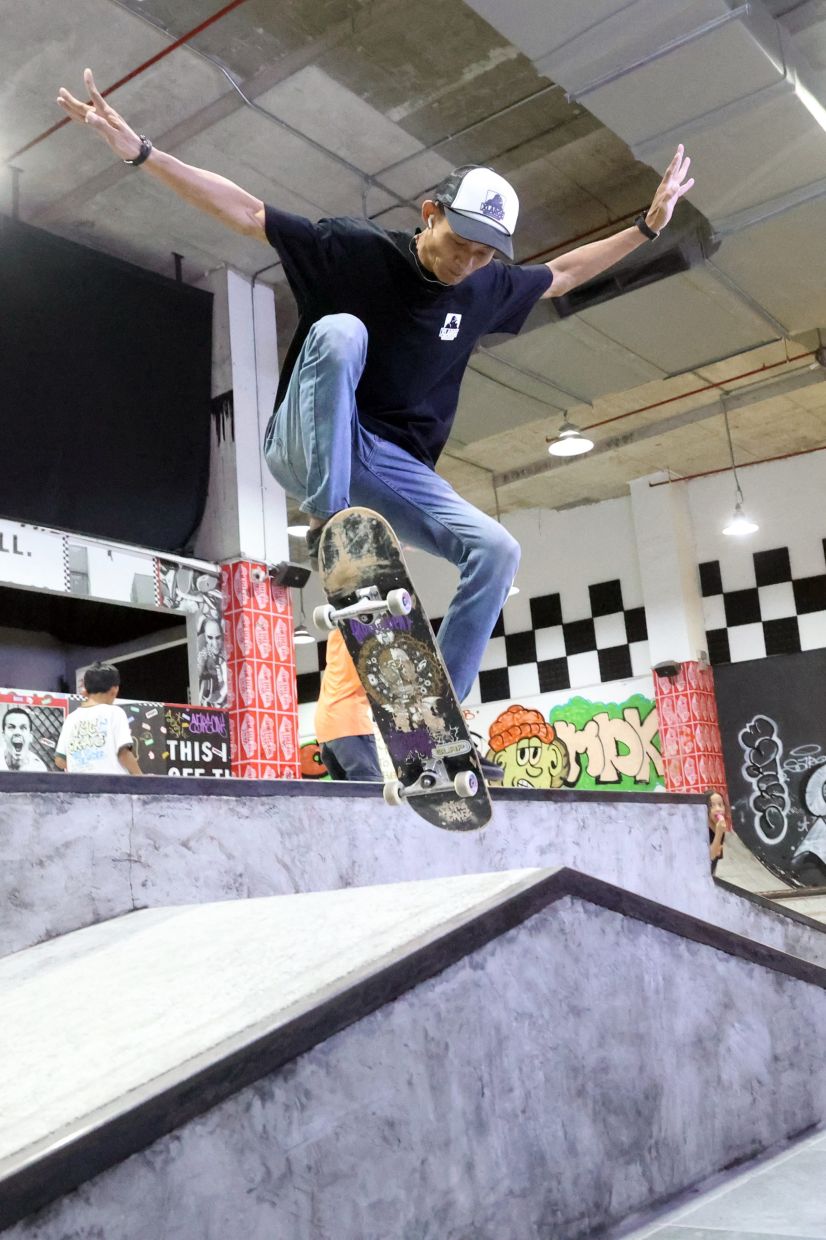 Skateboarding coach Ishak Idris demonstrating a trick to his students during a skate clinic at Showroom in Johor Baru. — Photos: THOMAS YONG/The Star
