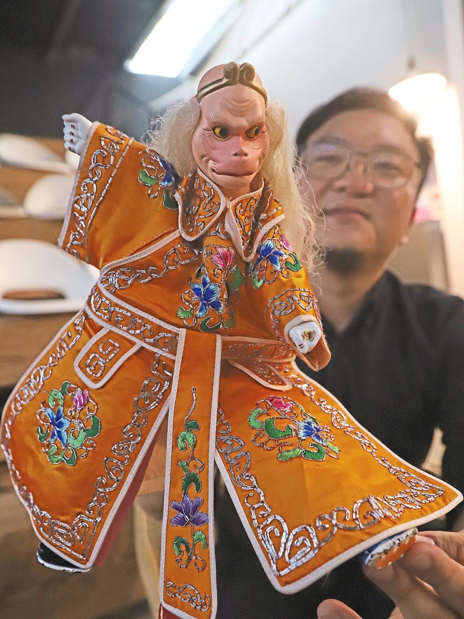Marcus showing a puppet of the mythological Monkey King.